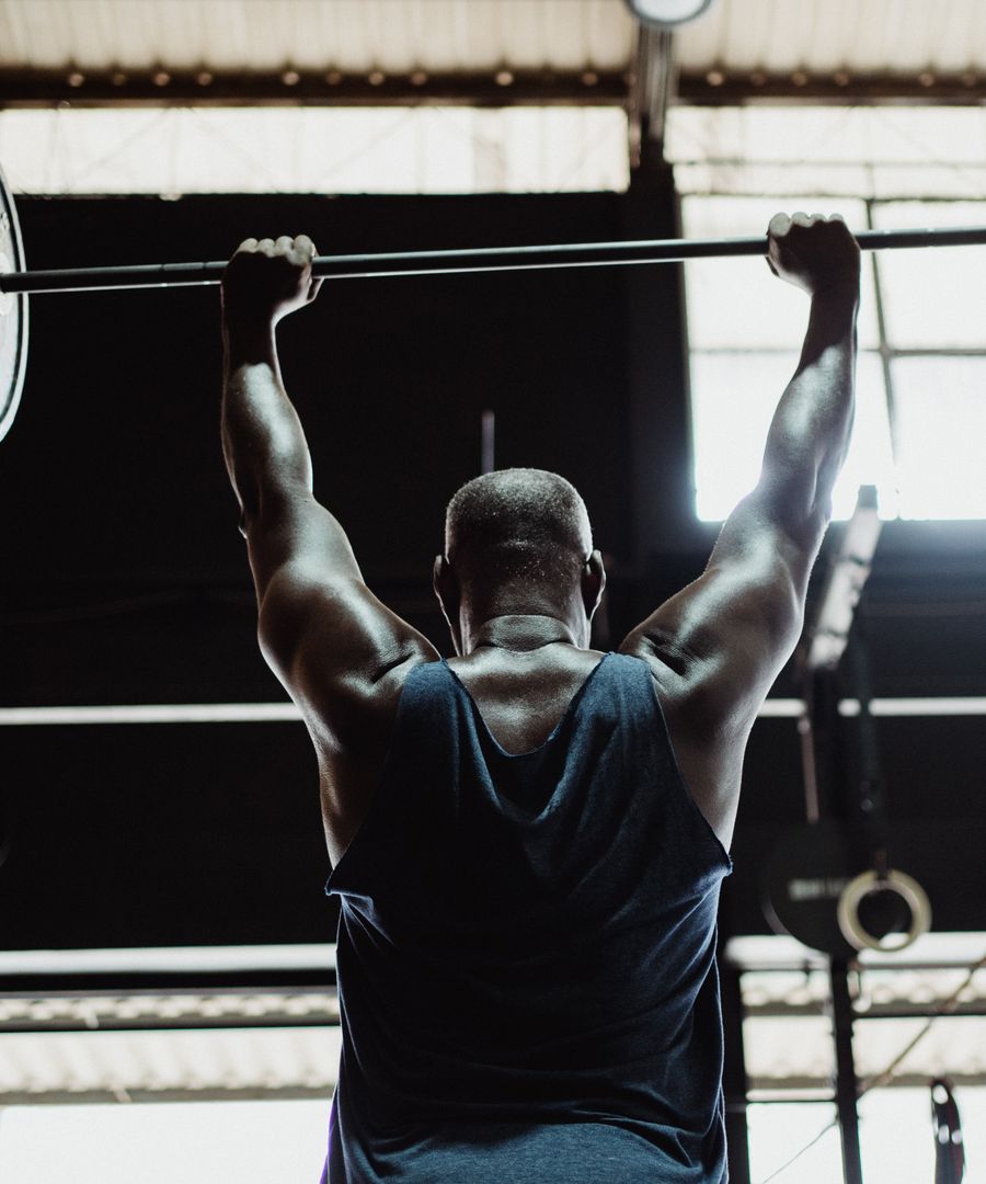 Strength training with a loaded barbell in a Detroit gym